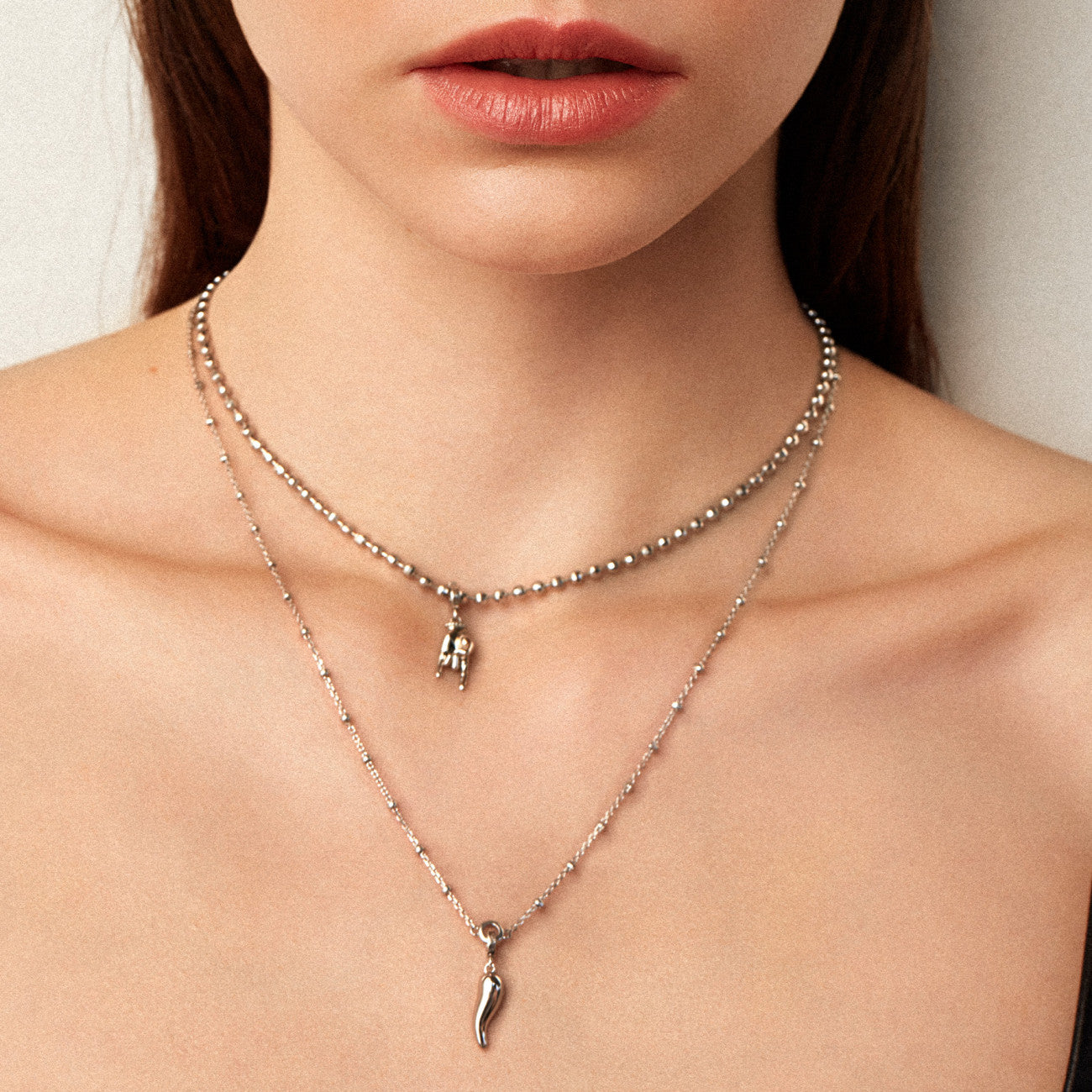 Charm Rosato Storie Mano corna